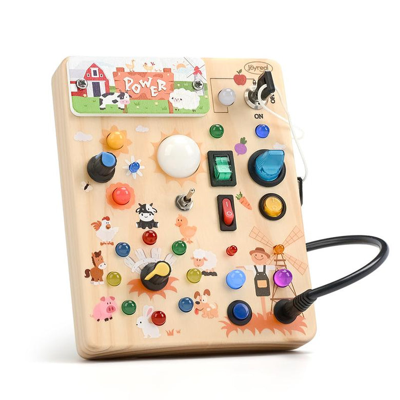 Farm-themed wooden busy board with switches, knobs and colored LED lights